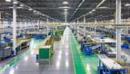 A wide shot of a manufacturing floor from an elevated perspective showing the overall environment